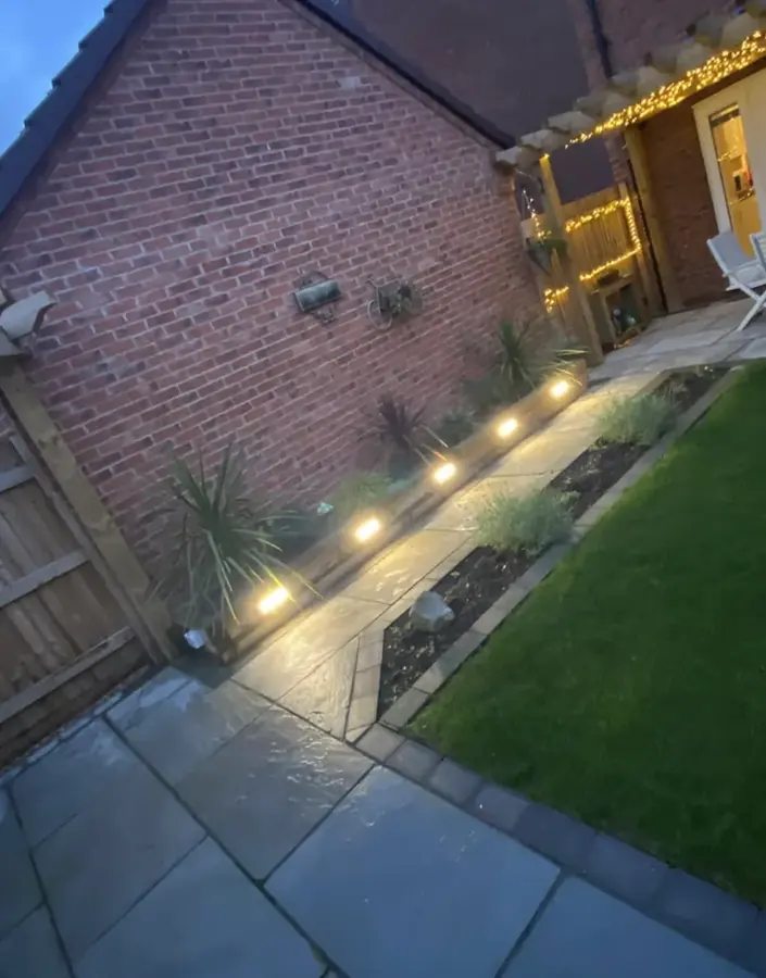 Lights sunk into a garden path at dusk