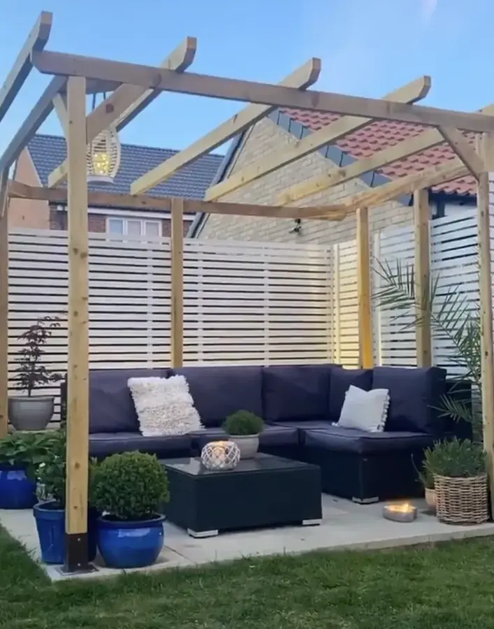 A pergola and seating area with lighting run in