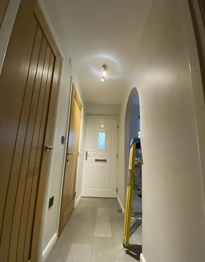Hallway lighting and an arched opening